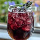 A sparkling lavender lemonade spritz with fresh lemon slices and lavender sprigs, perfect for summer entertaining.