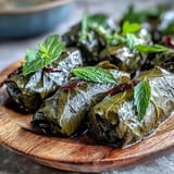 Tender Kurdish Dolma, stuffed grape leaves brimming with fragrant herbed rice, a delightful appetizer.
