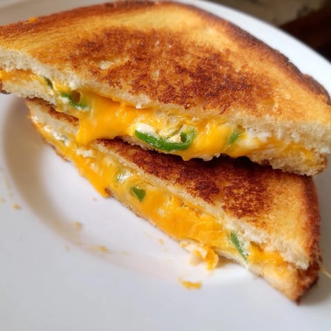 A close-up view of a spicy jalapeño popper grilled cheese, perfect for a hearty lunch.
